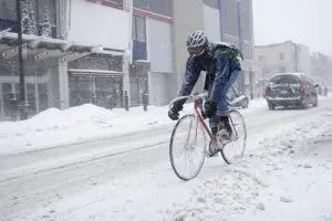 person delivering parcel in ottawa snow on bicycle